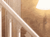 a lamp hanging on a wall next to a staircase railing