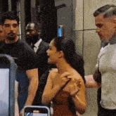 a woman in a strapless dress talks to a man in a suit