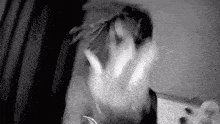 a black and white photo of a person 's face with a hand reaching out .