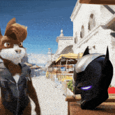 a batman helmet sits on a wooden table next to a cat