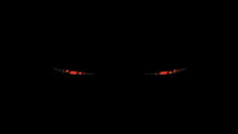 a pair of hypnotic eyes with a swirl pattern on them on a black background .