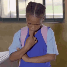 a little girl with braids and a pink backpack