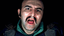 a man with a mustache sticking out his tongue