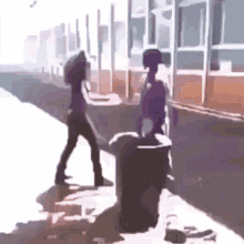 a man and a woman are standing next to each other on the sidewalk .