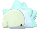 a pokemon is laying down on a white surface with a black spot on its face .