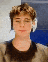 a young man wearing headphones and a black shirt