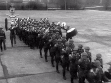 a black and white photo of a marching band with the letters eh on the bottom