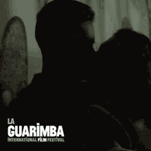 a poster for the la guarimba international film festival shows a man and woman kissing