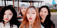 a group of young women are standing next to each other and smiling for the camera .