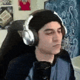 a man wearing headphones is sitting in a chair .