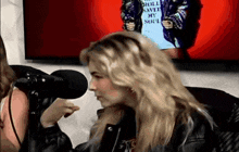 a woman talking into a microphone with a shirt that says " roll saved my soul " on it