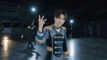 a man in a blue and gold outfit is giving the number four
