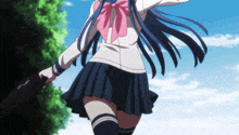 a girl in a school uniform with a pink bow holds a book