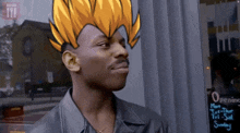 a man with a picture of a dragon ball z character on his head is standing in front of a window .
