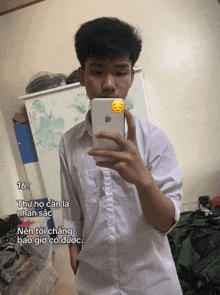 a young man is taking a selfie with a sticker on his phone that says 16