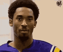 a close up of a basketball player with a beard wearing a blue jersey .