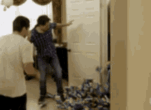 a man is standing in a room with a bunch of boxes on the floor .