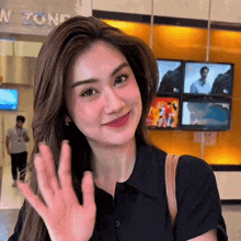 a woman waves her hand in front of a sign that says zone