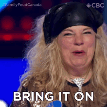 a woman says bring it on while wearing a hat