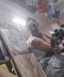 a woman is taking a picture of herself with her phone