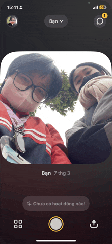 a phone screen shows two people taking a picture with the time of 15:41