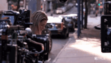 a netflix advertisement shows a woman behind a camera