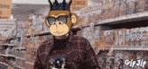 a monkey wearing sunglasses and a crown is standing in front of a lower price sign