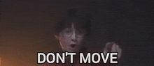 harry potter is standing in front of a fire with the words we 're still playing behind him