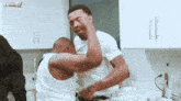 two men are fighting in a kitchen with a watermark that says variety
