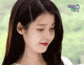 a close up of a woman 's face with a blue box that says " 아이유 " on it