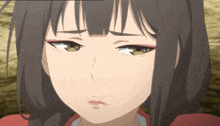 a close up of a girl 's face with a serious expression