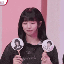 a girl in a black shirt is holding a fan with the name lili on it