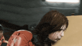 a man with long hair is wearing a red boxing glove with the word tfc on it