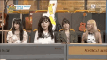 a group of girls sitting at a table with a sign that says magical mis