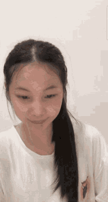 a girl with long hair is wearing a white shirt with a deer on the front