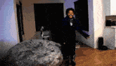 a person standing in a living room with a bean bag chair
