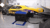 a yellow and purple racing car with the word ega on the side
