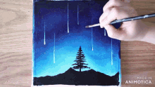 a person is painting a picture with the words made in animatica on the bottom right