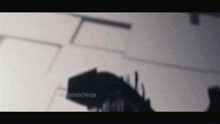 a shadow of a person is cast on a wall by a ninjaisticninja