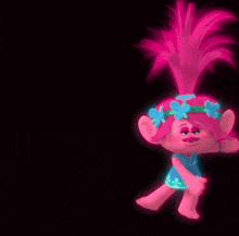 poppy from trolls is wearing a blue dress and a flower crown .