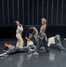 a group of young women are dancing on a stage .