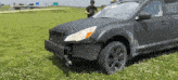 a man stands in front of a car with a damaged front bumper