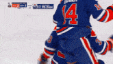 a hockey player in a blue jersey with the number 4 on it