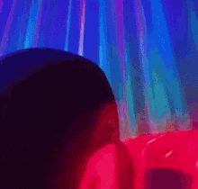 a close up of a person 's face with a red and blue light coming out of it .
