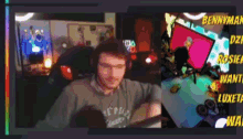 a man wearing headphones is sitting in front of a computer screen with the name bennyman written on the bottom