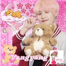 a boy with pink hair is holding a teddy bear with the words cute yangyang written on it