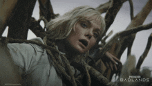 a movie poster for predator badlands shows a blonde woman