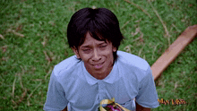 a man wearing a man laksa shirt is kneeling down