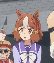 a girl in a purple uniform with the letter b on her ears