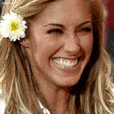 a close up of a woman 's face with a flower in her hair and the name anahita on the bottom